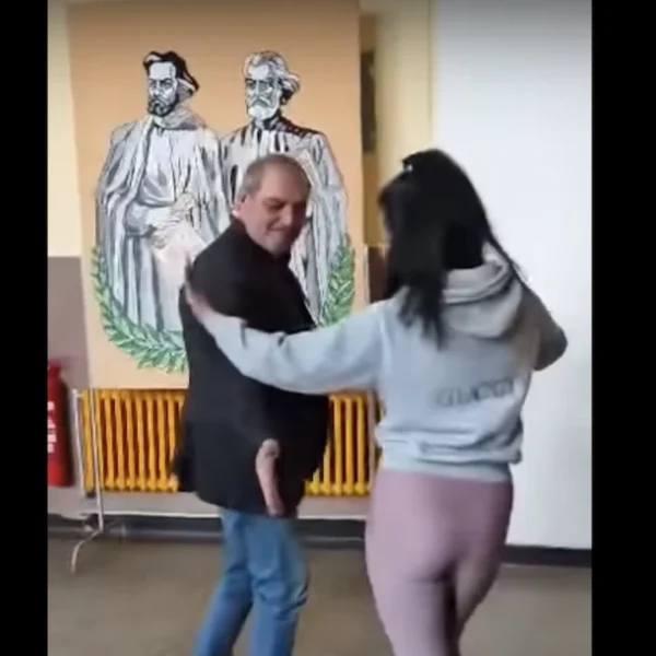 Скандално ВИДЕО: Директор на училище и ученичка въртят гюбеци пред портрета на Кирил и Методий